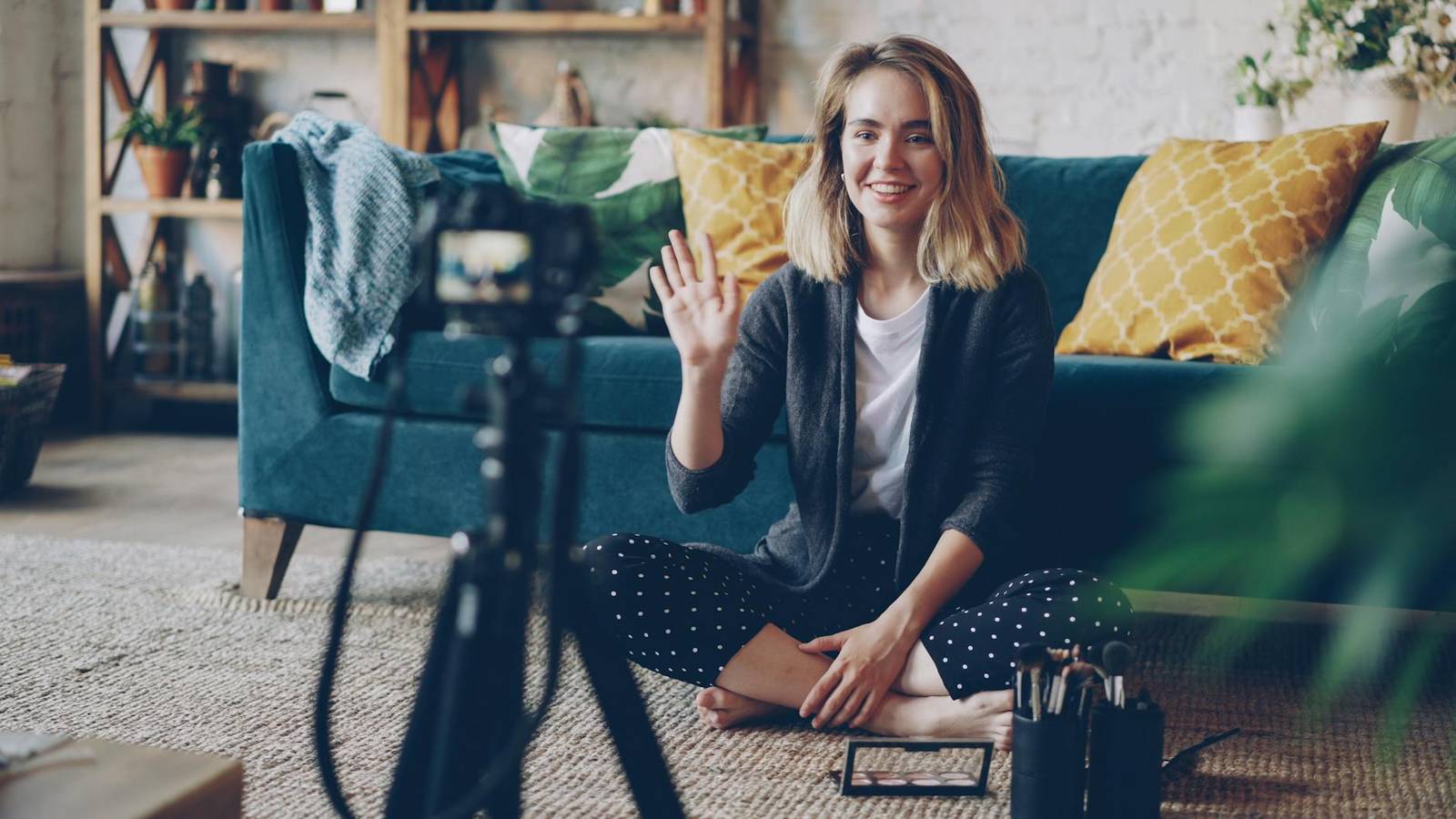 young woman vlogging from stylish living room