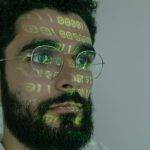 man in white crew neck shirt wearing silver framed eyeglasses