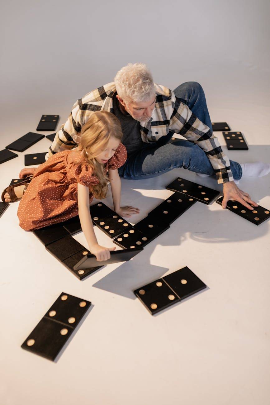 grandfather and granddaughter playing giant lawn dominoes