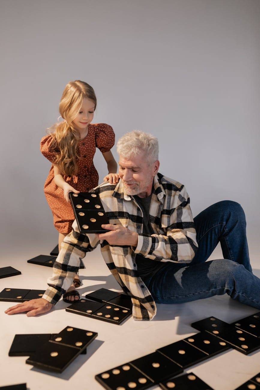 grandfather and granddaughter playing giant lawn dominoes