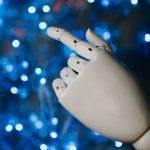 white robot hand in close up photography